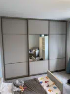 Cashmere panels with a mirror in the center of the middle door in brushed champagne frames, fitted in Wynyard
